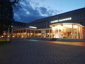 a large building with a sign that reads carolina garage at Meublé Symphonie in Niederbronn-les-Bains +5 photos