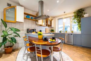 a kitchen with a wooden table and chairs at Apartamenty Centrum 50 m od Rynku, FREE PARKING in Nowy Targ
