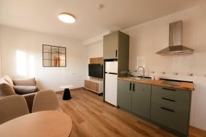 a kitchen and living room with a couch and a table at NUMA Beach Apartments in Aguadulce +30 photos