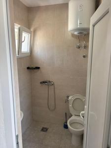a bathroom with a shower with a toilet and a sink at Apartments Sole 2 in Sutomore +55 photos