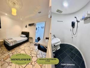 a bathroom with a bed and a sink in a room at CASA Homestay in Batu Pahat +29 photos