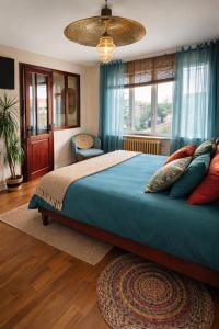 a bedroom with a large bed with blue sheets and pillows at B&B Villa Marie-Lou in Le Portel