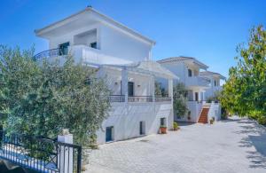 a large white house with a balcony at Scandia Villas in Potos