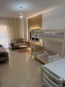 a living room with two bunk beds and a couch at Apartment Gerti - Sea view in Shëngjin