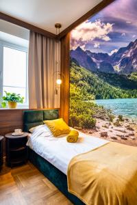a bedroom with a large painting of a lake at Apartamenty Centrum 50 m od Rynku, FREE PARKING in Nowy Targ