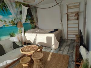 a room with a bedroom with a bed and a couch at Amos Coastal Escape Studio - Hanko in Hanko