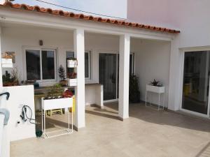 a patio with sliding glass doors on a house at Hostel do Mar in Carrapateira