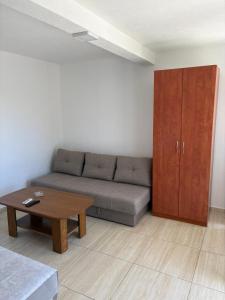 a living room with a couch and a coffee table at Apartments Sole 2 in Sutomore