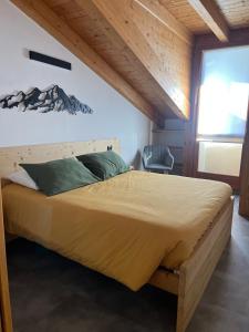 a bedroom with a large bed in a room at Mansarda Mitta Coel in Torre di Santa Maria