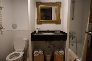 a bathroom with a toilet and a sink and a mirror at ZINC in Mutxamel