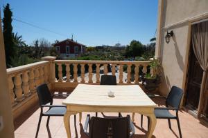 a wooden table and chairs on a balcony at ZINC in Mutxamel