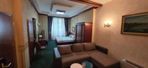 a living room with a couch and a bedroom at HOTEL ELSA in Skopje