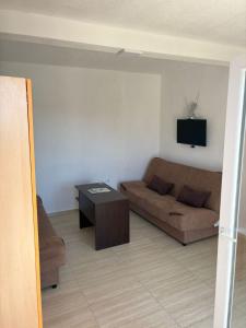 a living room with a couch and a table at Apartments Sole 2 in Sutomore