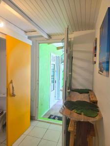 a room with a bed in a room with a doorway at L'Orange Volcanique in Saint-Pierre