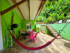 a porch with a hammock in a house at L'Orange Volcanique in Saint-Pierre