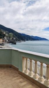 a balcony with a view of a beach and the water at La Terrazza sul Mare Affittacamere in Monterosso al Mare