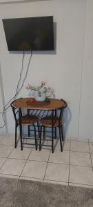 a table with a bowl of flowers on top of it at Sea flight in Preveza