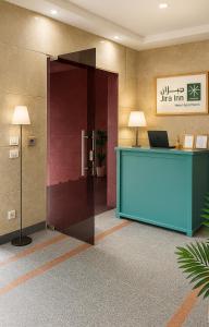 an office lobby with a desk and a glass door at Jira Inn Hotel - چيران in Cairo