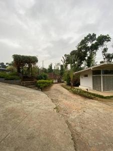 a house with a dirt road in front of it at Gope town mudigere in Mudigere