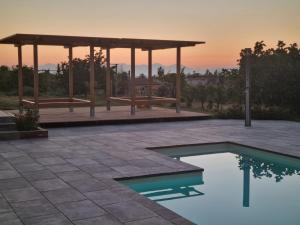 a pool with a gazebo and a picnic shelter at Cilento My Home in Albanella