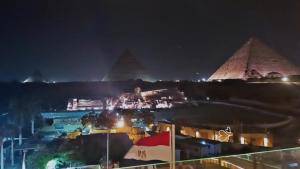 a view of the pyramids of giza at night at pyramids View Top in Cairo