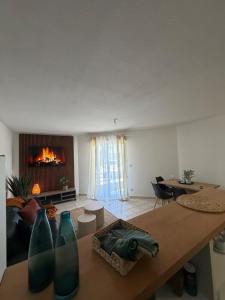 a living room with a fireplace and a table with vases at La Pause Larzac- T3 calme-terrasse - Proche Viaduc de Millau in La Cavalerie
