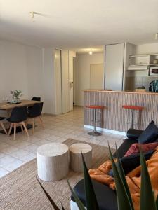 a living room with a couch and a table at La Pause Larzac- T3 calme-terrasse - Proche Viaduc de Millau in La Cavalerie +1 photo