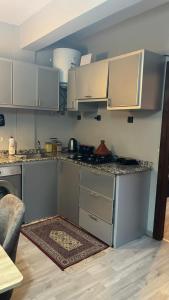a kitchen with white cabinets and a counter top at Andalous in Aït Ali