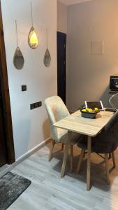 a dining room table and chairs with a bowl of fruit on it at Andalous in Aït Ali +2 photos