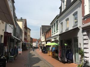a street in a town with shops and buildings at Captains Haven in Eckernförde