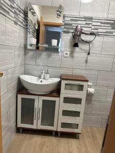 a bathroom with a sink and a mirror at Ferienwohnung Schulrath in Eichwerder