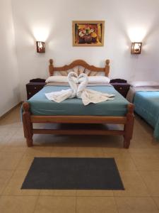 a bedroom with two beds with white towels on them at Hotel Maria Cafayate in San Carlos +16 photos