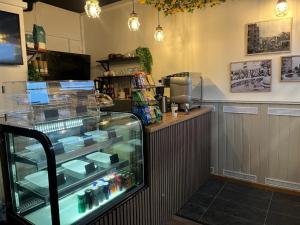 a store with a display case in a restaurant at Oxbackens Hotell & Café in Västerås
