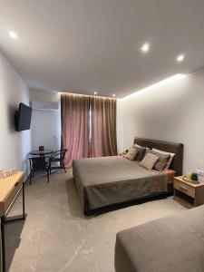 a bedroom with a bed and a table and a tableablish at Agathi Paradise Studios in Haraki