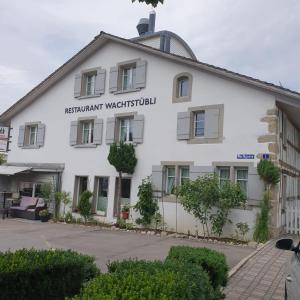a white building with a sign on it at Wachtgasse in Adliswil