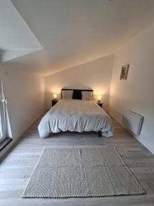 a bedroom with a bed with two lamps and a rug at gîte 6 personnes le cocon des pommes in Saint-Lambert-et-Mont-de-Jeux