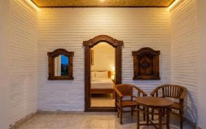 a room with a mirror and a table and a bed at Rumah Rini by Rumah Weda in Ubud +20 photos