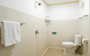 a bathroom with a toilet and a shower at Rumah Rini by Rumah Weda in Ubud
