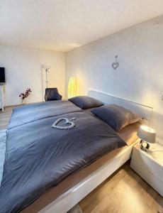 a bedroom with a large bed with a blue comforter at Sternlicht Rachida in Albstadt