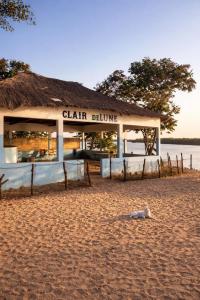 a building with a sign on the beach at Campement Clair de Lune - Chez Dam et Amcé in Kachiouane