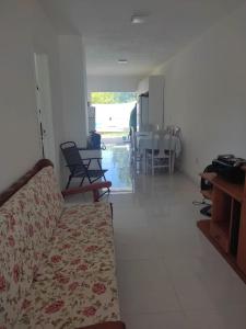 a living room with a couch and a table at Casa próxima a orla in Pelotas