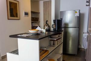 a kitchen with a stainless steel refrigerator at Confortable Apartamento Centro de Bogotá in Bogotá