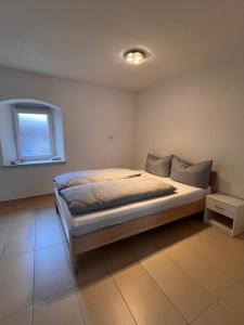 a bedroom with a bed and a window at Main Tauber Appartment in Lauda-Königshofen