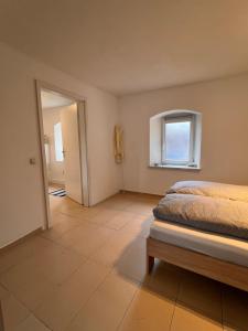 a bedroom with a bed and a window at Main Tauber Appartment in Lauda-Königshofen