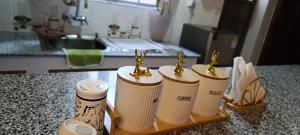 a group of threeulatedulated bottles with a trophy in a kitchen at Zangem Homes in Nairobi