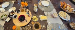 a table with a bunch of food on it at Mon Refuge B&B in Jougne