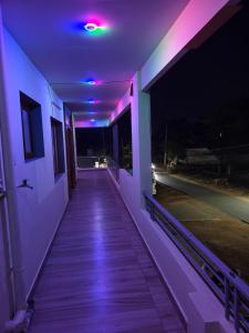 a hallway of a house at night with purple lights at Dev Homestay kakinada in Kākināda +4 photos