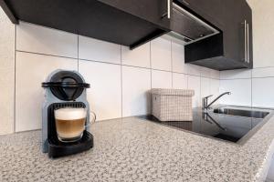 a cup of coffee sitting on a counter in a kitchen at Gîte de chandonne in Liddes