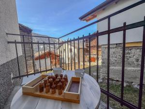 a wooden box on a table on a balcony at Gîte de chandonne in Liddes