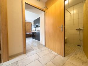 an open door to a bathroom with a kitchen at Gîte de chandonne in Liddes